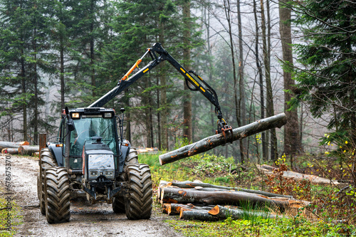 A specialized forest tractor working with logging in the rain in the Carpathians  Poland.
