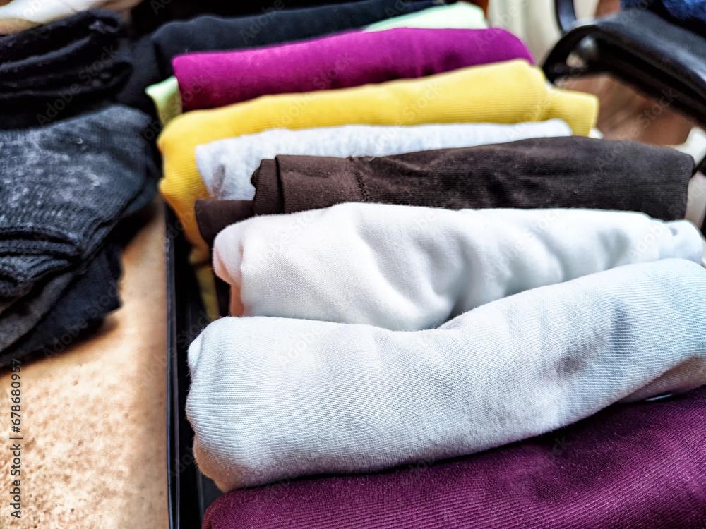 Tidy and organized clothes with the konmari method. Storage of T-shirts folded in a box Tidy and organized clothes with the konmari method. Storage of T-shirts folded in a box