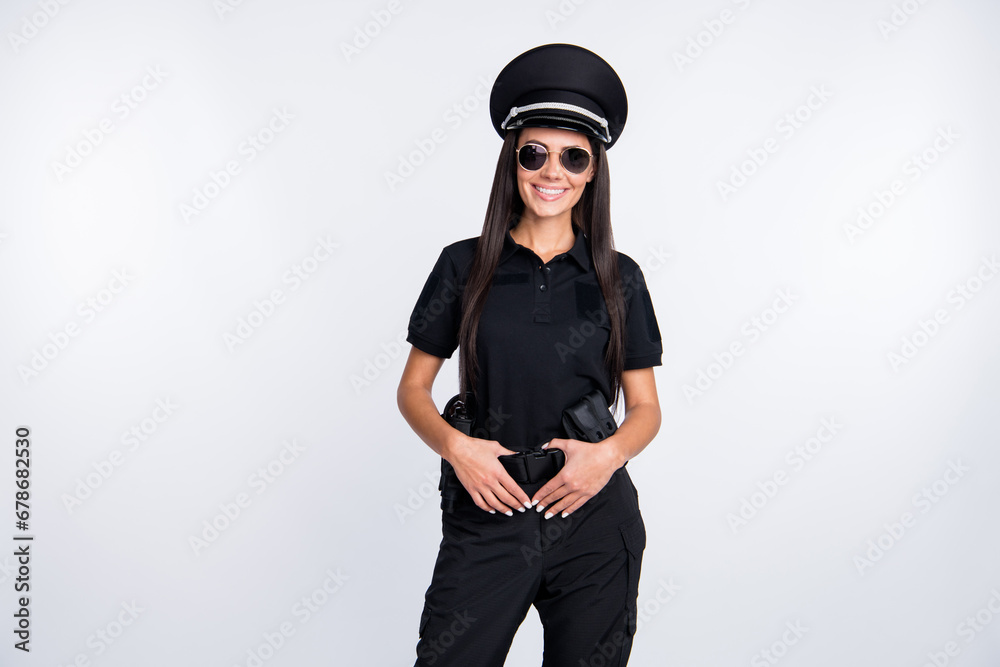 Photo of cute adorable policewoman dressed black clothes headwear dark spectacles arms weapon belt isolated white color background