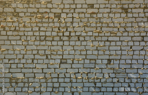 The texture of the wall of white brick, reinforced with careless and sloppy layers of mortar