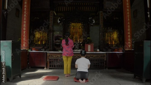 women praying in the vietnamese temple, finding harmony in the temple's embrace