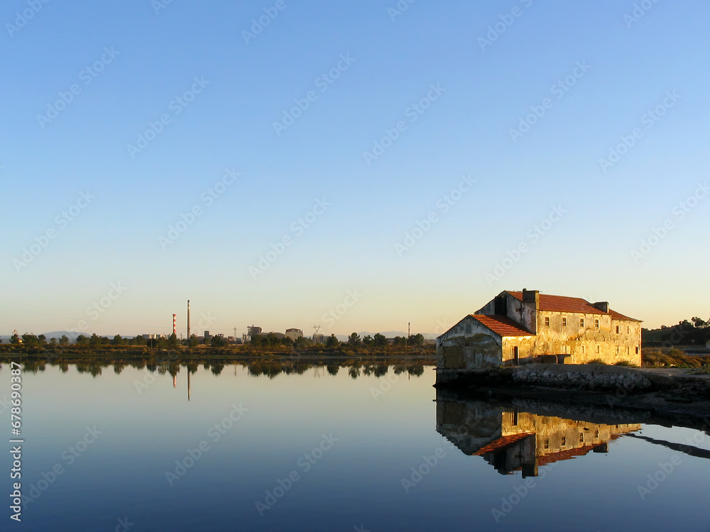 Old ruined Tide Mill and water mirror at Seixal Bay by sunset. One of the surviving Tide-Mills in Europe. Old ruined Tide Mill and water mirror at Seixal Bay by sunset. One of the surviving Tide-Mills in Europe.
