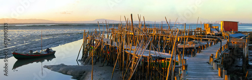Traditional fishermen wooden jetties. Stilt piers or Cais Palafitico by the Sado River estuary during low tide on Carrasqueira, Alcacer do Sal, Setubal, Portugal photo