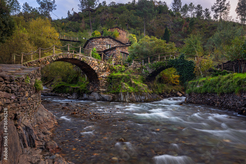 Schist houses and double bridge in historic shale village in Foz D Egua
Schist houses and double bridge in historic shale village in Foz D Egua (Portugal) photo