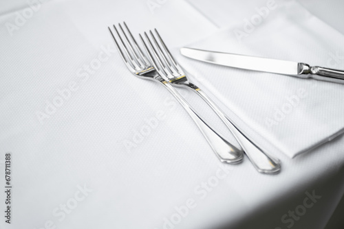 Close up view of cutlery, tablecloth and napkin from Elegant Restaurant table