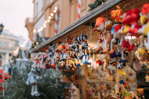 Cute shops with Christmas toys and decorations at the New Year city fair. Wooden house with lots of gifts. Christmas trinkets. New Year's crafts