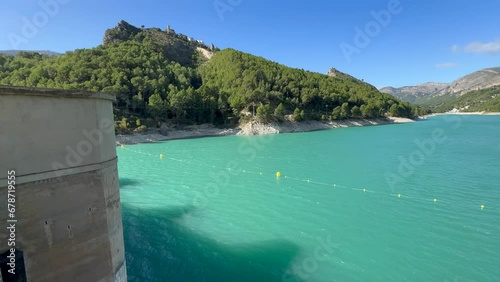 Panoramic view of a dam in a reservoir, in Guadalest village, Spain. The floodgates are open.	