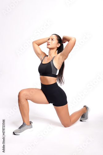 an asian woman is working out wearing the sport exercise suit with white background,