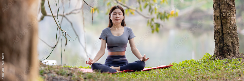 Asian woman doing yoga in nature in the forest, Meditation and breathing exercises, Treat ADHD and train your mind to be calm, Healthy exercise, Mindfulness, Homeopathy, Park yoga.