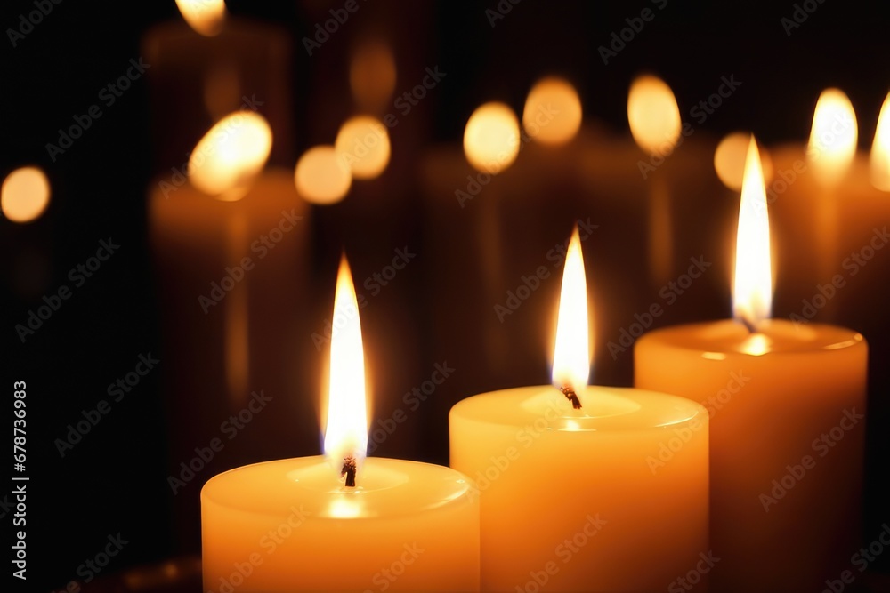 Burning candles on dark background, close-up Burning candles on dark background, close-up