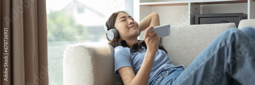 Woman happily listening to music on her favorite sofa in the living room  Relaxation time  Happy time  Feel good  Happy women resting at work after work is finished  Chill  Fatigue is eased.