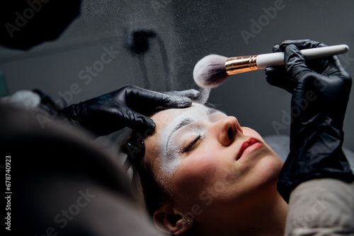 The makeup artist performs permanent makeup. Professional makeup and facial care. Eyebrow and lip tattooing. Cosmetologist. Beauty salon.
