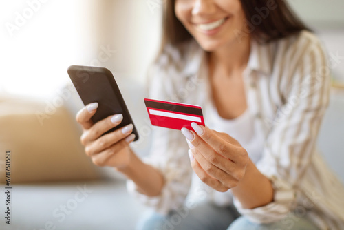 Online Shopping. Woman Using Smartphone And Credit Card At Home, Cropped