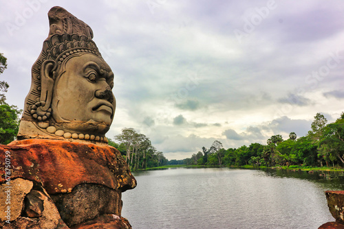Angkor Thom - Churning of the Ocean Hindu mythology scene Demon Head on the causeway with the moat in background at Siem Reap, Cambodia, Asia