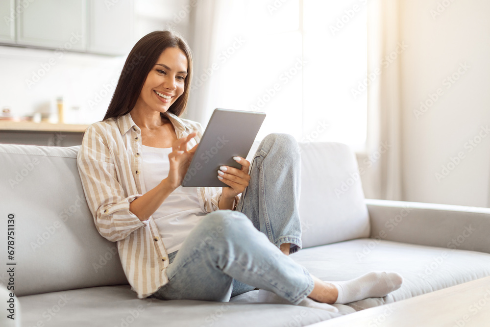 Beautiful young caucasian woman using digital tablet at home Beautiful young caucasian woman using digital tablet at home