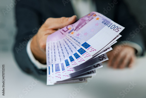 hand give 500 euro banknotes. bank money loan, consumer credit and quick loans concept photo