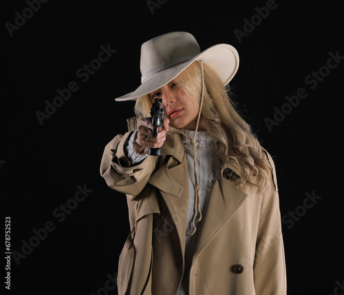 portrait of a beautiful blonde cowboy girl with a revolver photo