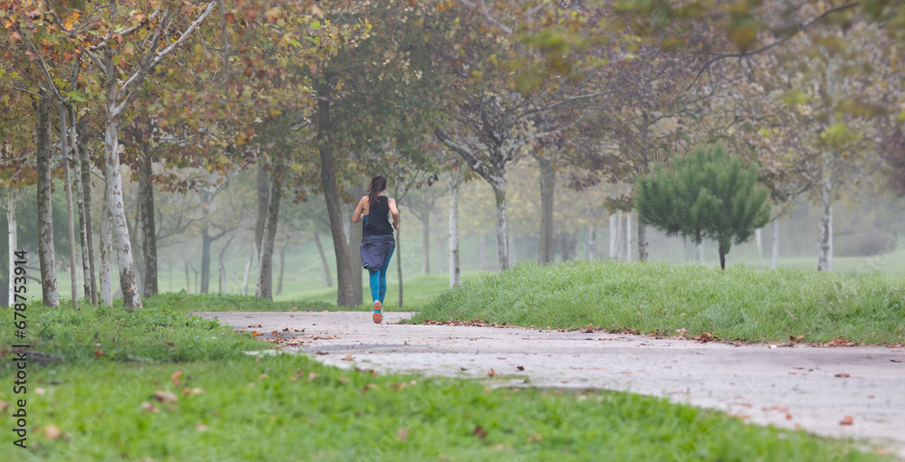 Fototapeta premium A woman running in park