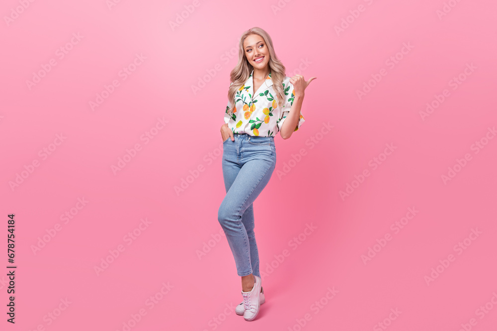 Full body photo of positive glamour sweet blonde girl direct finger copyspace information for customers isolated on pink color background Full body photo of positive glamour sweet blonde girl direct finger copyspace information for customers isolated on pink color background
