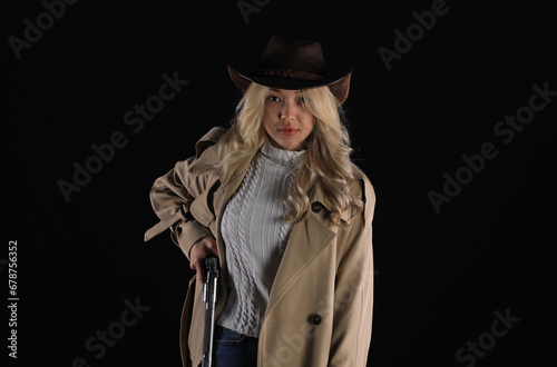 portrait of a beautiful blonde cowboy girl with a revolver photo