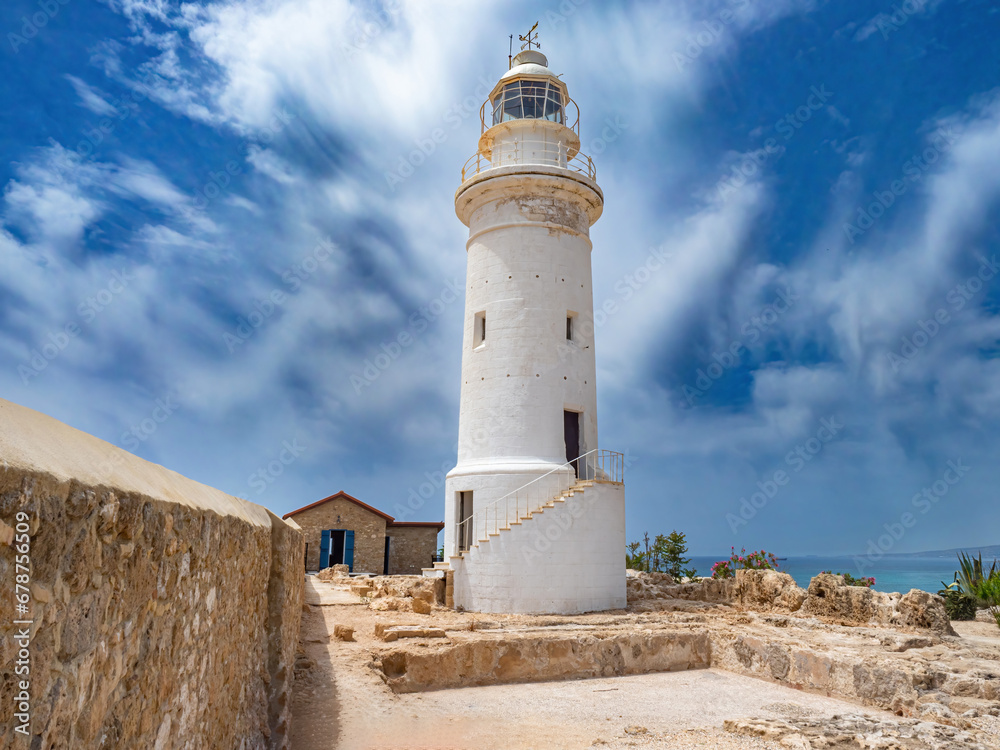 Island of Cyprus. City of Paphos. White lighthouse on seashore. Sights of Cyprus. Paphos in sunny weather. Lighthouse on territory of archaeological park. Tour of Paphos. Travel to Cyprus Island of Cyprus. City of Paphos. White lighthouse on seashore. Sights of Cyprus. Paphos in sunny weather. Lighthouse on territory of archaeological park. Tour of Paphos. Travel to Cyprus