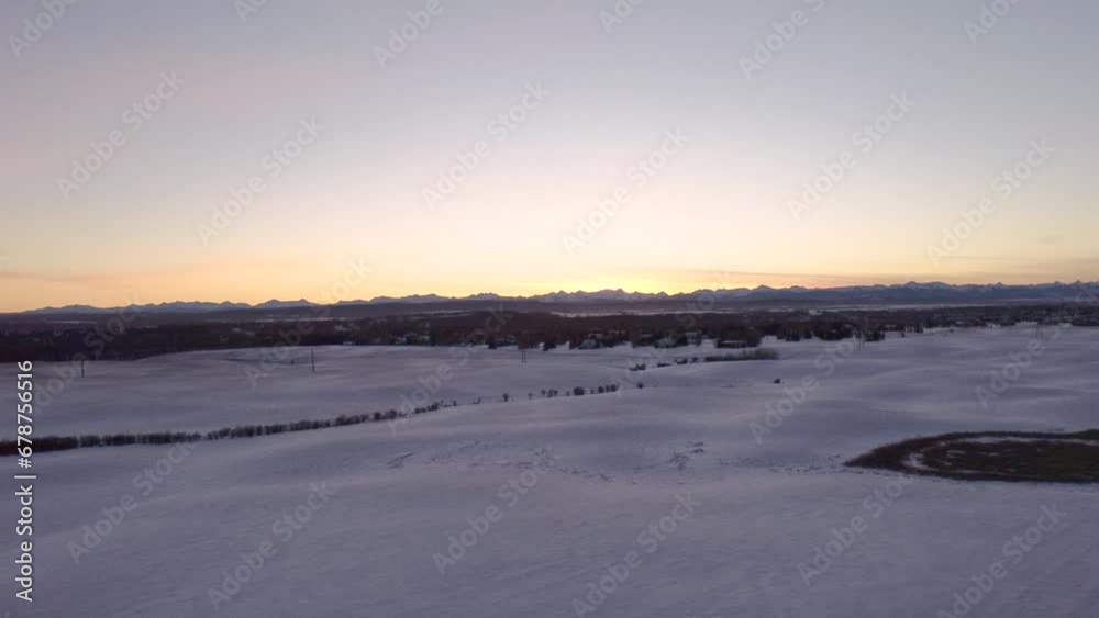 Aerial view of a large field covered with snow at sunset Aerial view of a large field covered with snow at sunset