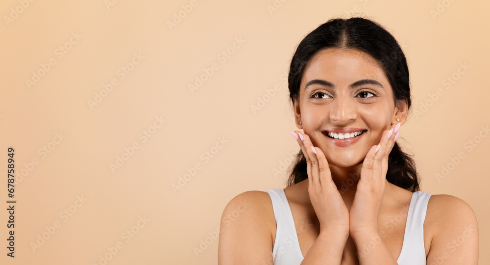 Beautiful Smiling Young Indian Lady Touching Face And Looking At Copy Space Beautiful Smiling Young Indian Lady Touching Face And Looking At Copy Space