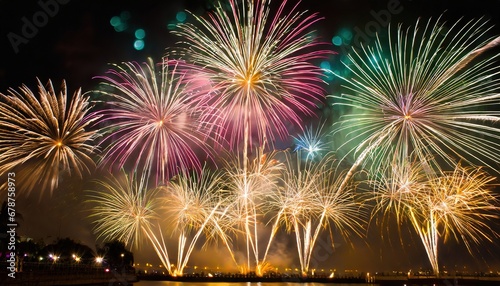 A stunning firework display illuminating the sky in celebration, set against a background of blurred bokeh lights.