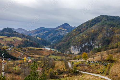 Mountain village in Serbia in bright autumn colors with Cemetery on the front