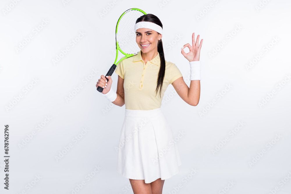 Portrait of attractive cheerful girl fit tennis player showing ok-sign goal success isolated over white color background Portrait of attractive cheerful girl fit tennis player showing ok-sign goal success isolated over white color background