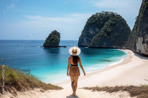 Beautiful woman in a straw hat on the beach of Phi Phi island, Thailand, rear view of a Woman walking at Kelingking Beach in Nusa penida island, Bali, Indonesia, AI Generated photo