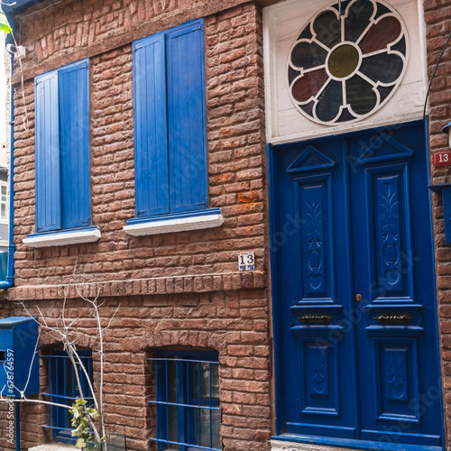 Old blue door on the brick facade of a house in Fatih Balat district of Istanbul. Narrow streets of the old city. photo