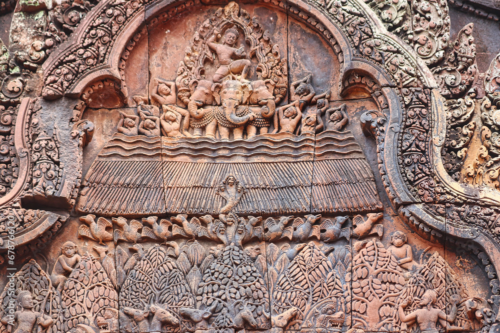 Stone Bas reliefs from hindu mythology at Banteay Srei - 10th century Hindu temple and masterpiece of old Khmer architecture at Siem Reap, Cambodia, Asia