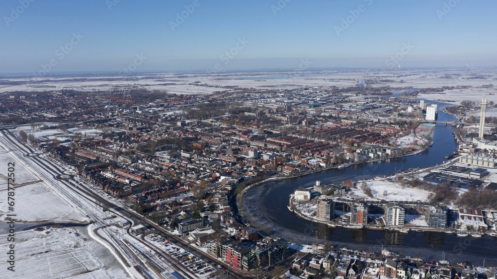 Aerial view of a snowy city with a river