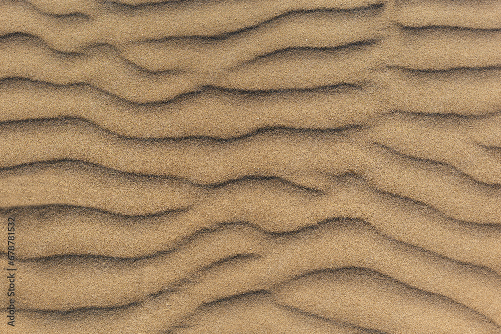 Dune waves and sand pattern. Wave, sand dunes. The sand changes shape due to the wind to form sand ripples and jagged lines. Selective focus. Copy space. Dune waves and sand pattern. Wave, sand dunes. The sand changes shape due to the wind to form sand ripples and jagged lines. Selective focus. Copy space.