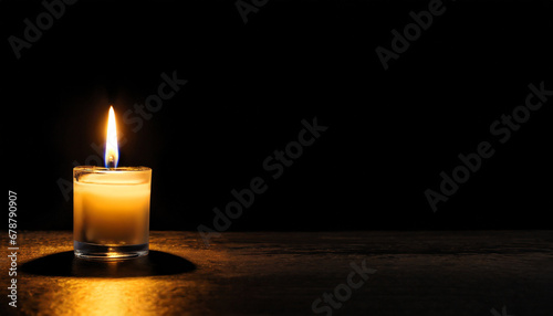 a candle burns in the darkness copy space a lit white candle on a black background the symbol of the eternal memory mourning moment of silence day of remembrance of loss banner or site header
