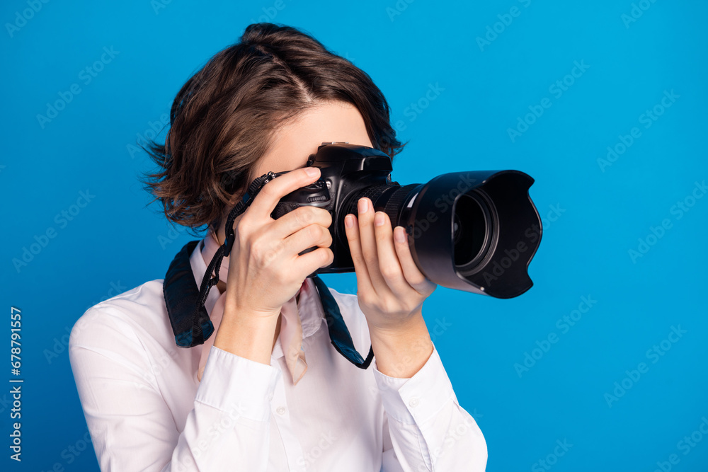 Profile portrait of young lady arms hold camera making pictures isolated on pastel blue color background Profile portrait of young lady arms hold camera making pictures isolated on pastel blue color background