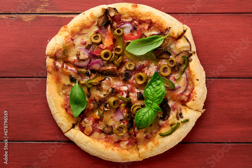 Homemade pizza. Traditional neapolitan pizza with olives, peppers, onions and mushrooms on wooden table backgrounds. Italian Traditional food. Top view. Mock up.