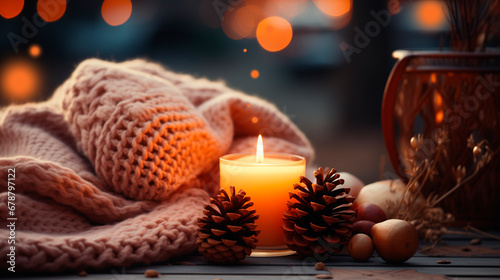 Christmas still life with candle and decorations on a wooden table.