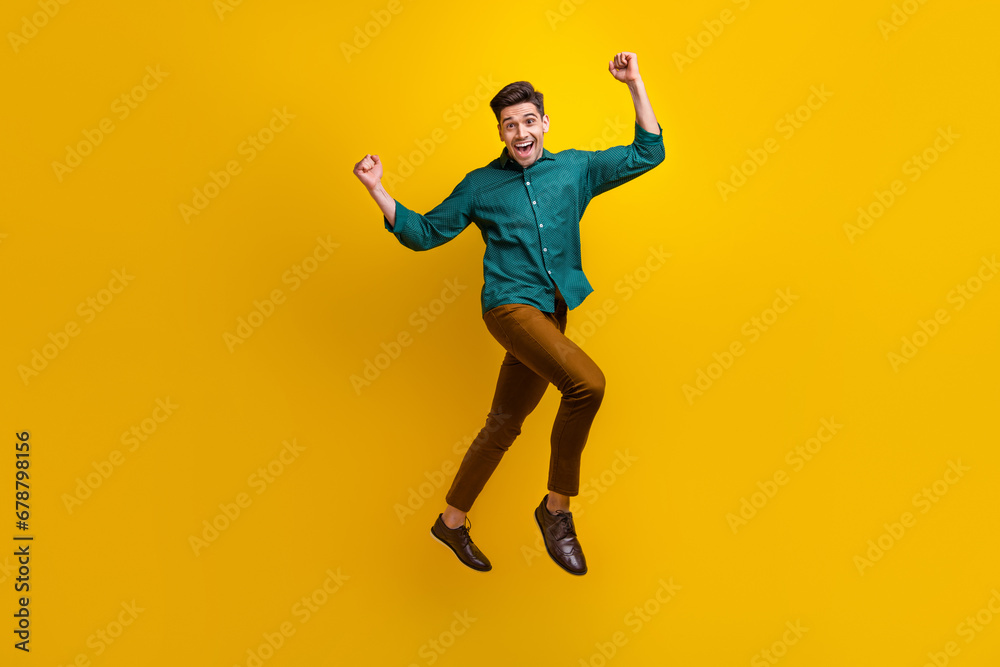 Photo of overjoyed cheerful glad man dressed stylish clothes celebrate black friday offer proposition isolated on yellow color background