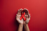 World AIDS Disease Day. Hands with red awareness ribbon on red background.