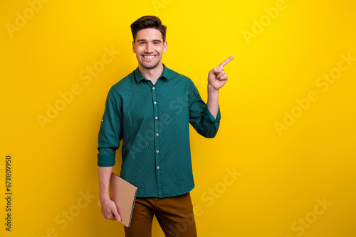 Photo of nice attractive man office manager wear stylish green outfit buy netbook macbook empty space isolated on yellow color background