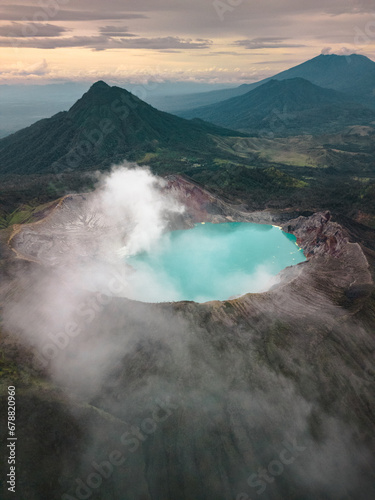 Aerial Serenity: Java's Mount Ijen at Sunrise, Revealing the World's Largest Highly Acidic Lake Amidst a Breathtaking Morning Sky. Nature's Wonder in Indonesia, Asia
