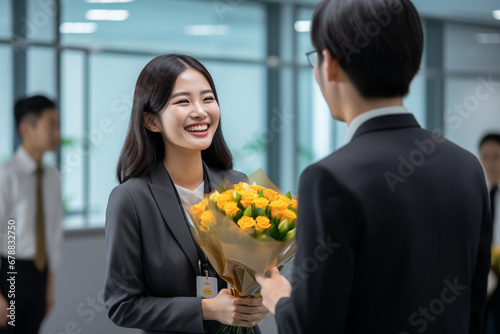 Young Asian female employee receiving recognition award from senior colleague. Proud employee in office celebration ceremony, achievement and success concept