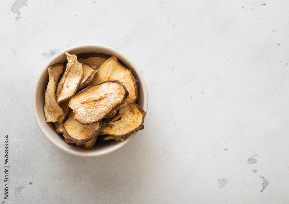 Top view of bowl with dried pear slices on light background.Macro. Top view of bowl with dried pear slices on light background.Macro.