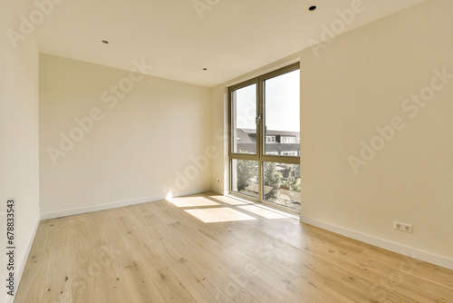 an empty room with wood flooring and large windows looking out onto the cityscapearrons com