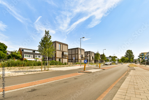 an empty street with houses in the background and blue skies overhead over the cityscapepngs com