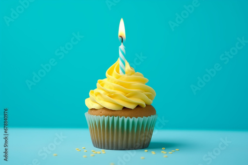 A birthday cupcake with a small candle on a blue background.