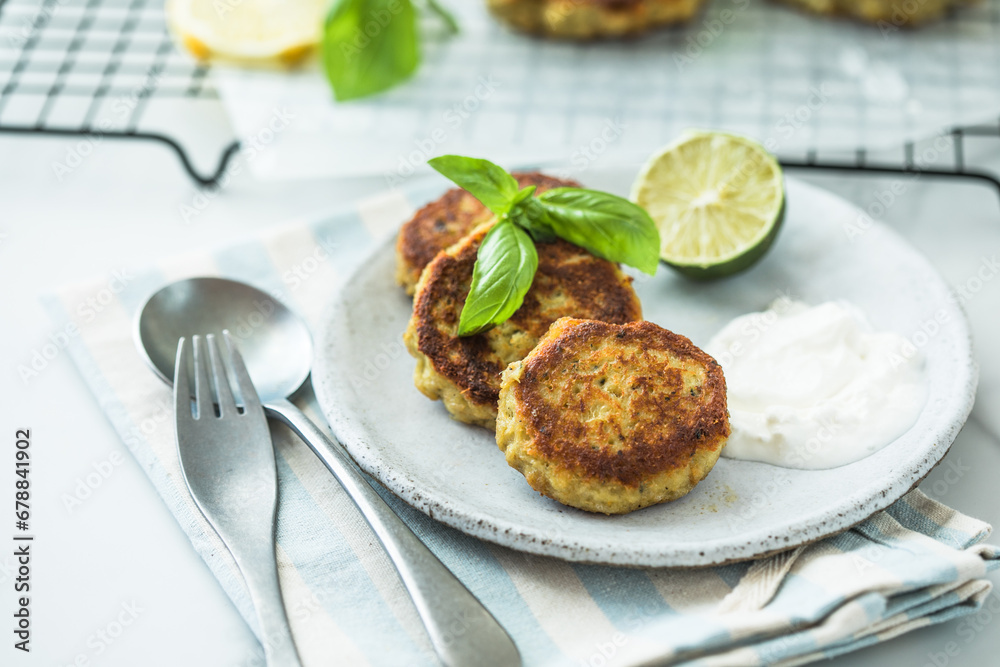 Traditional homemade fish cakes with tlemon and sour cream