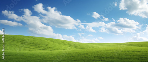 field and blue sky with clouds